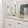 Pleasant Hill Apartments - Bathroom With Wood-Style Flooring, Granite Countertops, Large Mirror, Dual Sinks, Modern Decor, And Walk-In Glass Door Shower.